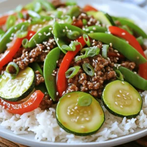 - 1 lb lean ground beef - 2 medium zucchinis, sliced into thin half-moons - 1 red bell pepper, sliced - 1 cup snap peas, trimmed - 3 cloves garlic, minced - 2 tablespoons fresh ginger, grated - 3 tablespoons soy sauce (or tamari for gluten-free) - 1 tablespoon sesame oil - 2 green onions, sliced - Sesame seeds - 1 teaspoon crushed red pepper flakes (optional) In this healthy zucchini beef stir-fry, the main ingredients bring a fresh taste. Ground beef adds protein, while zucchini, red bell pepper, and snap peas offer great crunch. These veggies are not just colorful; they also provide vitamins and minerals. Aromatics play a big role too. Garlic and ginger give a strong flavor that makes the dish pop. Soy sauce and sesame oil add depth, making every bite a delight. If you like heat, crushed red pepper flakes can add a spicy kick. Lastly, green onions and sesame seeds can make this dish look and taste even better. They add a nice crunch and a pop of flavor. You can find the full recipe to guide you through the cooking steps. Enjoy your meal! - Heat the Oil: Start by placing a large skillet or wok over medium-high heat. Add 1 tablespoon of olive oil and let it heat until shimmering. This step is key to getting a good sear on the beef. - Cook the Beef: Add 1 pound of lean ground beef to the skillet. Use a spatula to break it apart as it cooks. Sauté until it turns brown and is fully cooked, which should take about 5 to 7 minutes. If there’s too much fat, drain it carefully. - Sauté Aromatics: Once the beef is cooked, push it to one side of the skillet. On the empty side, add 3 cloves of minced garlic and 2 tablespoons of grated fresh ginger. Sauté for about 30 seconds. You want both to be fragrant and slightly softened. - Add Vegetables: Now, combine the sliced zucchinis, 1 sliced red bell pepper, and 1 cup of trimmed snap peas into the skillet. Stir everything together well. Cook for an additional 5 to 7 minutes. The veggies should be tender yet crisp. - Flavor it Up: Drizzle 3 tablespoons of soy sauce and 1 tablespoon of sesame oil over the stir-fry. If you like a bit of heat, sprinkle in 1 teaspoon of crushed red pepper flakes. Toss all the ingredients thoroughly so everything is well-coated. - Marry the Flavors: Let the stir-fry cook for another 2 minutes. This step allows all the flavors to blend beautifully. Once done, remove the skillet from heat. - Garnish and Serve: Finally, before you serve, sprinkle the dish with sliced green onions and sesame seeds. This adds both flavor and a nice touch for presentation. This recipe is quick and brings tons of flavor to your plate. For the full recipe, check out the details above! - Ideal heat level: Use medium-high heat for a great stir-fry. This heat helps the beef sear and the veggies stay crisp. If the heat is too low, the food will steam instead of fry. - Cooking timing for vegetables: Add the veggies in stages. Start with the heartier snap peas and bell pepper, then add the zucchini later. Zucchini cooks fast and should stay slightly firm. Aim for around 5-7 minutes of cooking time for the vegetables. - Alternative protein options: You can swap ground beef for chicken, turkey, or tofu. Each will bring a new flavor. Use the same cooking method for all proteins. - Vegetable variations: Get creative with your veggies! You can add broccoli, carrots, or mushrooms. Just make sure to cut them into similar sizes for even cooking. - Low-sodium sauce options: To cut back on salt, look for low-sodium soy sauce or tamari. You can also dilute regular sauce with a bit of water. This keeps flavor while reducing sodium. - Adding more veggies: Boost nutrition by adding extra vegetables. Try spinach, baby corn, or bell peppers. The more colorful your stir-fry, the better it looks and tastes! For more detailed cooking steps, check out the Full Recipe. {{image_4}} You can add fun flavors to your stir-fry. Try using Asian-inspired seasonings like five-spice powder or hoisin sauce. These will give your dish a nice kick. You can even add nut butter, like peanut or almond. This makes the stir-fry rich and tasty. Meal prep can save you time. Start by pre-chopping your vegetables. Store them in airtight bags or containers. This makes cooking fast and easy. You can also batch cook the stir-fry for the week. Just heat it up when you’re ready to eat. If you need gluten-free options, use tamari instead of soy sauce. This keeps the flavor while making it safe for you. For those following a paleo diet, skip the soy sauce and use coconut aminos. This adjustment keeps your meal healthy and delicious. To keep your healthy zucchini beef stir-fry fresh, follow these tips: - Let the stir-fry cool down before storing. - Use airtight containers to prevent moisture loss. - Store leftovers in the fridge for up to 3 days. When reheating, you have two main options: - Microwave: Place your stir-fry in a microwave-safe dish. Heat for 1-2 minutes, stirring halfway. - Stovetop: Put the stir-fry in a pan over medium heat. Stir often for about 5 minutes until warm. To ensure freshness, always check for any off smells or changes in texture before eating. If you want to freeze your stir-fry, follow these steps: - Let the dish cool completely before freezing. - Use freezer-safe bags or containers. Remove as much air as possible. - Label with the date for easy tracking. To thaw, place the container in the fridge overnight. You can also cook from frozen. Just add a few extra minutes to your cooking time on the stovetop. Enjoy the full recipe for a delicious meal that’s easy to store! It takes about 20 minutes to make healthy zucchini beef stir-fry. You need 10 minutes for prep and 10 minutes for cooking. This quick time makes it great for busy weeknights. Yes, you can use other meats. Chicken, turkey, or pork work well. You can also try tofu for a vegetarian option. Just cook them the same way as the beef. This stir-fry pairs well with rice or quinoa. You can also serve it with a salad or steamed veggies. These sides balance the meal and add more nutrition. Yes, you can meal prep this stir-fry. Cook it, let it cool, and store it in the fridge. It lasts up to three days. You can reheat it quickly for lunch or dinner. Look for zucchini that is tender but still crisp. It should be slightly translucent and bright green. Avoid overcooking, as it can become mushy. Enjoy the fresh flavor and texture! This blog post covered a healthy and tasty zucchini beef stir-fry. You learned about the main ingredients, useful cooking tips, and various flavor twists. Remember to master the heat and timing to get it just right. You can also swap ingredients to fit your needs. With these ideas and instructions, you can create a delicious meal anytime. Enjoy experimenting and making this dish your own!