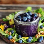 Fresh blueberries are the star of this vinaigrette. They add a sweet and tangy flavor. Choose ripe, plump berries for the best taste. You need 1 cup of fresh blueberries, rinsed clean. Their vibrant color makes the dressing inviting and bright. For this recipe, I use apple cider vinegar. It has a mild, fruity taste that pairs well with blueberries. You will also need 1/4 cup of high-quality extra virgin olive oil. This oil adds richness and depth to the vinaigrette. Together, they create a balanced flavor that enhances your salads. To sweeten the vinaigrette, you can use honey or pure maple syrup. Both options work well, but honey is not vegan. For a vegan option, stick with maple syrup. You only need 2 tablespoons to achieve the perfect sweetness. Adjust the amount based on your taste. To make this vinaigrette, gather all your ingredients first. You need 1 cup of fresh blueberries, rinsed well. Next, measure out 1/4 cup of apple cider vinegar and 1/4 cup of high-quality extra virgin olive oil. You will also need 2 tablespoons of honey or pure maple syrup for a vegan option. Lastly, grab 1 teaspoon of Dijon mustard, along with salt and freshly ground black pepper to taste. Start by adding the rinsed blueberries to a blender or food processor. Pour in the apple cider vinegar next. Then, add the honey or maple syrup and the Dijon mustard. Blend the mixture on high speed. This should take about 30 seconds until it's smooth and creamy. While the blender runs, very slowly drizzle in the olive oil. This helps create a nice emulsion, mixing all the flavors well. After blending, taste the vinaigrette. You may want to add salt and ground black pepper to enhance the flavor. If the vinaigrette feels too thick, add a tablespoon of water. Blend again to reach your desired consistency. Once done, transfer the vinaigrette into a jar or airtight container. For the best taste, refrigerate it for at least 30 minutes before serving. You can find the full recipe above for more details! To make a great emulsion, it’s key to add the oil slowly. Start blending the blueberries and vinegar. Then, while the blender runs, drizzle the olive oil in. This method helps the oil mix well with the other ingredients. The result will be a creamy and smooth vinaigrette. Keep the blender on medium speed to avoid breaking the emulsion. You can boost the flavor by adding a pinch of salt or pepper. A squeeze of lemon juice adds brightness. Try different sweeteners like agave or honey. Fresh herbs like mint or basil can add a nice twist too. Experimenting with flavors can lead to your perfect blueberry vinaigrette. This vinaigrette shines on salads. Drizzle it over mixed greens, grilled chicken, or roasted veggies. You can also use it as a dip for fresh veggies. For a fun twist, serve it with cheese and crackers. The sweet and tangy taste pairs well with many dishes. For the full recipe, check out the Fruity Blueberry Bliss Vinaigrette. {{image_4}} You can change the sweet taste of your vinaigrette. If you want less sugar, try using stevia or agave nectar. Both options work well and keep the flavor bright. You can also use brown sugar for a deeper taste. Each sweetener gives a unique twist to your blueberry vinaigrette. Experiment and find what you love best! Adding herbs can make your vinaigrette even more exciting. Fresh basil or mint will give it a refreshing kick. Just chop a few leaves and blend them with the other ingredients. You can also try using thyme or rosemary for a savory touch. These herbs blend well with blueberries and add depth to your dressing. Blueberries are just the start. You can mix in other fruits for fun flavors. Try raspberries or strawberries for a sweet and tart combo. Or add mango for a tropical twist. Apples can also work well, giving a nice crunch. Each fruit adds its own taste, making your vinaigrette special and unique. Don't forget to check the Full Recipe for more ideas! Store your blueberry vinaigrette in a clean jar. Make sure it is airtight. This keeps it fresh and prevents any odors from mixing in. Always let the vinaigrette cool down before sealing. When stored properly, blueberry vinaigrette lasts up to one week in the fridge. After that, the flavors may fade. Always check for any signs of spoilage before using it. If you freeze the vinaigrette, thaw it in the fridge overnight. This way, it stays safe to eat. After thawing, give it a good shake or stir to mix the ingredients well. You can use it on salads, as a marinade, or even drizzle it on grilled meats. For more details, check the Full Recipe. Yes, you can use frozen blueberries. They work well in this recipe. Just let them thaw first. This helps with blending them smoothly. Frozen blueberries still have great flavor. They may make your vinaigrette a little thicker. If you find it too thick, add a bit of water. You can store your homemade vinaigrette for up to one week. Keep it in an airtight jar in the fridge. This helps maintain its fresh flavor. Always give it a good shake before using. If it thickens, add a splash of water to thin it out. Blueberry vinaigrette pairs well with many dishes. It tastes great on mixed green salads. Try it on spinach, arugula, or kale. It also complements grilled chicken or fish. You can drizzle it over roasted vegetables for added flavor. Yes, you can make this vinaigrette without honey. Substitute it with pure maple syrup for a vegan option. You can also use agave syrup or just skip the sweetener. If you prefer a tangy taste, reduce the vinegar a little. Yes, you can use other types of vinegar in this recipe. Balsamic vinegar adds a rich flavor. Red wine vinegar gives a nice twist. Try white wine vinegar for a lighter taste. Each type will change the flavor a bit, so experiment to find your favorite. This blog post covered how to make a tasty blueberry vinaigrette. We discussed the key ingredients, like fresh blueberries and vinegar choices. You learned the step-by-step process, along with tips for the best results. We explored fun variations, storage tips, and answered common questions. Making blueberry vinaigrette is simple and delicious. This dressing can add flavor to many dishes. Try different ingredients and methods to find what you love. Enjoy your cooking!