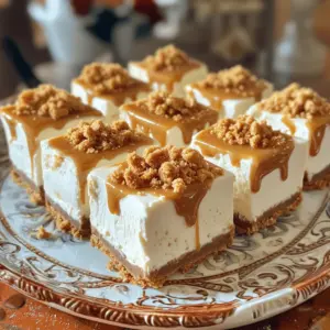 To make the No-Bake Biscoff Cheesecake Squares, you need simple yet delicious ingredients. Here’s what you’ll need: - 200g Biscoff cookies, finely crushed - 100g unsalted butter, melted - 400g cream cheese, softened at room temperature - 200g Biscoff spread, plus extra for drizzling - 100g powdered sugar - 1 teaspoon pure vanilla extract - 200ml heavy whipping cream - Additional crushed Biscoff cookies for topping Each ingredient plays a key role in bringing these squares to life. The Biscoff cookies provide a sweet, spiced flavor, while the cream cheese adds that creamy texture. The Biscoff spread enhances the taste, making it rich and indulgent. Using unsalted butter helps bind the crust, giving it a nice crunch. Powdered sugar adds sweetness without grittiness. The heavy whipping cream is essential for that light and fluffy texture. Lastly, the vanilla extract brings warmth and depth to the flavor. Gather these ingredients, and you’ll be ready to create a dessert that impresses everyone. Start by mixing the Biscoff cookie crumbs with melted butter. Use a spatula to combine them well. The mixture should feel crumbly but hold together. Next, transfer the crumb mixture into a 9x9-inch square baking dish. Press down firmly using a measuring cup or your fingers. Aim for a compact, even layer. Now, chill the crust in the fridge while you prepare the filling. This step helps the crust set up nicely. In a large mixing bowl, add softened cream cheese, Biscoff spread, powdered sugar, and vanilla extract. Use an electric mixer to beat the mixture on medium speed. Keep mixing until it is smooth and creamy. You want to avoid lumps in your filling. This creates a rich, velvety texture in your cheesecake squares. In a separate bowl, whip the heavy cream with an electric mixer or by hand. Keep whipping until stiff peaks form. This means the cream holds its shape well. Next, gently fold the whipped cream into the Biscoff mixture. Use a spatula to combine them carefully, keeping the air in the whipped cream. This makes your cheesecake light and fluffy. Pour the filling over the crust and spread it evenly with a spatula. Cover the baking dish with plastic wrap or a lid. Place the cheesecake in the fridge for at least 4 hours. For the best results, let it chill overnight. Once set, carefully lift the cheesecake out using the edges. Cut it into squares and place them on a serving plate. Drizzle with extra Biscoff spread and sprinkle crushed Biscoff cookies on top for a pretty finish. - Overmixing the cheesecake filling: This can make the filling too thin and airy. Beat just until smooth. - Not chilling long enough: A proper chill helps the squares set. I recommend at least 4 hours. - Recommendations for the cream cheese temperature: Use cream cheese at room temperature. This makes it easier to blend. - Importance of whipped cream consistency: Whip the cream until stiff peaks form. This helps keep the filling light and fluffy. - Ideas for garnishing: Drizzle extra Biscoff spread on top. Sprinkle crushed Biscoff cookies for added crunch. - Pairing options for enhancing flavor: Serve with fresh berries or a scoop of vanilla ice cream. This adds a fresh touch to each bite. {{image_4}} You can make your No-Bake Biscoff Cheesecake Squares even more exciting. Try adding different extracts like almond or coconut. A dash of cinnamon or nutmeg can bring warmth. If you love chocolate, drizzle melted dark chocolate on top. You can also layer caramel sauce for a sweet surprise. If you want a dairy-free treat, use vegan cream cheese. Coconut whipped cream works well instead of heavy cream. For the crust, swap regular butter with coconut oil. This keeps the same great taste while making it dairy-free. Make your cheesecake squares festive for any holiday. For Halloween, add orange food coloring to your filling. For Christmas, try gingerbread spices in the crust. You can top your squares with sprinkles for birthdays. Use themed cookie cutters to create fun shapes. These small changes will make your dessert special for any occasion. To keep your no-bake Biscoff cheesecake squares fresh, store them in the fridge. Use an airtight container to prevent them from drying out. Make sure the lid fits snugly. You can also cover the dish tightly with plastic wrap. This keeps moisture in and odors out. The cheesecake squares will stay fresh for up to five days in the fridge. You can freeze these cheesecake squares if you want to save some for later. First, cut them into squares. Place each square on a baking sheet lined with parchment paper. Freeze them for about two hours until firm. Then, transfer the squares to an airtight container or a freezer bag. Make sure to separate layers with parchment paper to avoid sticking. When you want to serve them, take them out and thaw in the fridge for a few hours. They taste great after thawing and are just as creamy and delicious! No-Bake Biscoff Cheesecake Squares last about 5 to 7 days in the fridge. Store them in an airtight container to keep them fresh. This helps prevent them from absorbing strong smells from other foods. If you want to keep them longer, consider freezing them. Yes, you can use other cookies for the crust. Graham crackers work well for a classic taste. Oreos or chocolate wafers can add a fun twist. Just crush them finely and mix with melted butter as you would with Biscoff cookies. If you don’t have Biscoff spread, try using Nutella or almond butter. Each spread will change the flavor slightly. Nutella will add a rich chocolate taste, while almond butter gives a nutty flavor. Adjust the sugar in the recipe to balance sweetness, if needed. This blog post covered how to make No-Bake Biscoff Cheesecake Squares. We explored ingredients, step-by-step instructions, tips for success, variations for creativity, and storage methods. Remember, using the right ingredients and chilling the cheesecake is key. Whether you stick to the recipe or try new flavors, these treats are sure to impress. Enjoy creating your delicious cheesecake squares, and share them with friends and family!