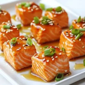 - 1 lb salmon fillet, skinless - 3 tablespoons teriyaki sauce - 1 tablespoon honey - 1 tablespoon sesame oil - 2 green onions, chopped - 1 teaspoon minced garlic - 1 teaspoon grated ginger - Sesame seeds for garnish - Salt and pepper to taste The main ingredients in this recipe are key for flavor. Salmon offers a rich taste and healthy fats. Teriyaki sauce brings a sweet and savory kick. Honey adds a hint of sweetness that balances the sauce. Sesame oil gives a nice nutty aroma. Next, we have the aromatics. Green onions add freshness. Minced garlic provides depth. Grated ginger adds warmth and zing. Sesame seeds are not just for looks; they add crunch. Finally, you&rsquo;ll season with salt and pepper to enhance all these flavors. Make sure to gather all these ingredients before you start. This will make the cooking process smooth and fun! {{ingredient_image_1}} To start, gather your ingredients for the marinade. You will need teriyaki sauce, honey, sesame oil, minced garlic, and grated ginger. In a mixing bowl, combine: - 3 tablespoons teriyaki sauce - 1 tablespoon honey - 1 tablespoon sesame oil - 1 teaspoon minced garlic - 1 teaspoon grated ginger Mix these well to blend the flavors. This marinade will coat the salmon and give it a rich taste. Next, take your salmon fillet and cut it into bite-sized cubes. Add these cubes to the marinade. Make sure each piece is well coated. Let the salmon sit in the marinade for 15 to 20 minutes. This step helps the salmon absorb all the yummy flavors. Now, it's time to cook! Preheat your air fryer to 400&deg;F (200&deg;C) for about 5 minutes. This step ensures even cooking. While the air fryer heats up, lightly grease the basket with cooking spray. This helps prevent sticking. Once ready, arrange the marinated salmon bites in a single layer in the basket. Be careful not to overcrowd the basket. Cook the salmon bites for 8 to 10 minutes. Halfway through, shake the basket gently for even crispness. The salmon should turn golden brown and be fully cooked. For the best taste, marinate your salmon for at least 15-20 minutes. This time allows the salmon to soak up the teriyaki sauce, honey, and spices. If you have more time, you can marinate it for up to an hour. The longer it sits, the more flavor it gets. Before you start cooking, preheat your air fryer to 400&deg;F (200&deg;C) for about 5 minutes. This step helps your salmon cook evenly. To keep your salmon from sticking, spray the air fryer basket with cooking spray. A light coat is all you need. This way, you can easily remove your salmon bites after cooking. To get that nice crisp, shake the basket halfway through cooking. This action helps the salmon cook evenly on all sides. You want to make sure that every piece gets that golden brown color. A good shake is key to making your bites extra tasty. Pro Tips Marinate Longer for Flavor Boost: For an even deeper flavor, consider marinating the salmon bites for up to 1 hour. This allows the flavors to penetrate the fish more thoroughly. Check for Doneness: Salmon is perfectly cooked when it flakes easily with a fork and has an internal temperature of 145&deg;F (63&deg;C). Use a meat thermometer for accuracy. Customize Your Marinade: Feel free to experiment with the marinade by adding ingredients like sriracha for heat, or lime juice for brightness. Tailor it to your taste preferences! Serve with a Side: These teriyaki salmon bites pair wonderfully with steamed rice or a fresh salad, making for a well-rounded meal. Consider adding some pickled vegetables for extra crunch. {{image_2}} You can change the flavor of your salmon bites by using different sauces. For a spicy kick, try sriracha or chili garlic sauce. If you love citrus, mix orange juice and soy sauce. You can also use a miso glaze for a rich and umami taste. Each sauce gives a new twist to the dish. Adding vegetables to your air fryer salmon bites makes the meal more nutritious. You can toss in bite-sized broccoli or bell peppers. Snap peas and zucchini also work well. These veggies cook quickly and add color and crunch to your dish. Just make sure to cut them small so they cook evenly. Pair your teriyaki salmon bites with rice or quinoa for a complete meal. Steamed jasmine rice complements the flavors well. You can also serve them with a fresh salad for a light option. For extra fun, make lettuce wraps with the salmon and veggies. Each bite will be bursting with flavor! To store your air fryer teriyaki salmon bites, first, let them cool. Place the bites in an airtight container. You can keep them in the fridge for up to three days. If you want to save them longer, freeze them. Use a freezer-safe bag or container. This way, they won't get freezer burn. When it's time to enjoy leftovers, the air fryer is your best friend. Preheat your air fryer to 350&deg;F (175&deg;C). Place the salmon bites in the basket in a single layer. Heat them for about 5-7 minutes. This keeps them crispy and tasty. Check to ensure they are warmed through before serving. These salmon bites are best when fresh. In the fridge, they last about three days. If you freeze them, they can last for up to three months. Just remember to label your container with the date. This helps you keep track of how long they&rsquo;ve been stored. I recommend marinating the salmon for at least 15 to 20 minutes. This time allows the fish to absorb the rich flavors of the teriyaki sauce, honey, and spices. If you have more time, you can marinate it longer, up to an hour. Just remember, the longer it sits, the more flavor it gains. Yes, you can use frozen salmon. However, you should thaw it first. Place the frozen salmon in the fridge overnight or run it under cold water for quicker thawing. Once thawed, dry the salmon well before cutting it into cubes and marinating. This helps the marinade stick better, giving you tasty bites. If you don&rsquo;t have teriyaki sauce, you can make a simple mix. Combine soy sauce, honey, and a splash of rice vinegar. You can also add a bit of garlic and ginger for extra flavor. This mixture works well as a marinade too and keeps your salmon bites delicious. This blog post covered how to make delicious air-fried salmon bites using simple ingredients. You learned how to prepare the marinade, marinate the salmon, and air fry it for perfect crispiness. I shared tips for flavor and storage, plus variations to keep the dish exciting. Try these salmon bites for a quick meal that&rsquo;s easy to customize. You can impress your friends and family with great taste and texture. Enjoy your cooking!