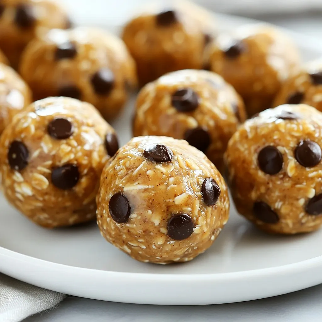 To make these tasty peanut butter protein balls, gather these simple ingredients: - 1 cup natural peanut butter - 1/2 cup rolled oats - 1/4 cup honey or maple syrup - 1/4 cup chocolate protein powder - 1/4 cup ground flaxseed - 1/2 teaspoon vanilla extract - 1/4 cup mini chocolate chips (optional) - A pinch of sea salt These ingredients work well together. Each one adds a unique taste and texture to the protein balls. You can make these protein balls even better by adding a few optional ingredients: - Chopped nuts for crunch - Dried fruits like raisins or cranberries - A sprinkle of cinnamon for warmth These extras can make your snack more fun and tasty. Mix and match to find what you like best! If you want to switch things up, try different sweeteners or protein powders. Here are some ideas: - Use agave syrup or coconut sugar instead of honey or maple syrup. - Swap out chocolate protein powder for vanilla, or use plant-based protein powder. These changes let you customize the flavor and fit your diet. Enjoy exploring new options! {{ingredient_image_1}} Start by grabbing a large mixing bowl. Add 1 cup of natural peanut butter, 1/4 cup of honey or maple syrup, and 1/2 teaspoon of vanilla extract. Use a spoon to stir them together until smooth. Next, add 1/2 cup of rolled oats, 1/4 cup of chocolate protein powder, 1/4 cup of ground flaxseed, and a pinch of sea salt. Mix all these ingredients until they are well blended. If you want some added sweetness, fold in 1/4 cup of mini chocolate chips. Once your mixture is ready, it’s time to form the balls. Use your hands to take small amounts of the mixture, about 1 inch in size. If the mixture feels sticky, wet your hands slightly with water. This will help you roll the balls easily. Place each ball on a baking sheet lined with parchment paper. Make sure to leave some space between them. After rolling the balls, put the baking sheet in the refrigerator. Let them chill for at least 30 minutes. This helps them firm up and hold their shape. Once chilled, transfer the protein balls to an airtight container. Store them in the fridge for up to a week. You can also freeze them for longer storage. Enjoy your easy and healthy snack anytime! Each peanut butter protein ball has about 100 calories. This makes them a great snack choice. If you roll 12 balls, you get around 1,200 calories total. Keep this in mind when you snack. These protein balls are rich in protein and healthy fats. Each ball has about 3 grams of protein. They also offer 7 grams of carbs and 5 grams of fat. The oats and flaxseed add fiber and omega-3s. Vitamins and minerals come from the peanut butter and oats too. Peanut butter is full of healthy fats. It helps keep you full longer. Oats are great for energy and digestion. Flaxseed is packed with fiber and can aid heart health. Honey or maple syrup gives a natural sweetness and quick energy boost. This snack is not just tasty; it also supports your health! Pro Tips Use Natural Peanut Butter: Opt for natural peanut butter without added sugars or oils for a healthier, creamier texture. Add Variety: Experiment with different protein powders or mix-ins like chia seeds, dried fruits, or nuts for unique flavors. Chill for Better Texture: Allow the power balls to chill in the fridge for at least 30 minutes to help them firm up and hold their shape. Perfect Storage: Store the power balls in an airtight container in the fridge for up to a week or freeze for longer storage options. {{image_2}} When making peanut butter protein balls, some mistakes can happen. First, do not skip the chilling step. Chilling helps the balls hold their shape. If you rush this step, your balls may fall apart. Second, avoid using too much liquid. The mix should be thick, so keep an eye on the amounts. Lastly, be careful with the salt. A pinch is enough; too much can overpower the taste. To get the best texture, use natural peanut butter. It has less sugar and better flavor. Mix the peanut butter and honey well before adding other ingredients. This helps everything blend smoothly. If the mix is too dry, add a bit more honey or peanut butter. If it is too sticky, add a bit more oats or protein powder. Use your hands to roll the balls, and if they stick, wet your hands slightly. You can easily change the flavor of your protein balls. Try adding a scoop of cocoa powder for a chocolate twist. You can also mix in chopped nuts or seeds for crunch. Dried fruit like raisins or cranberries adds sweetness and chewiness. For a fun twist, use flavored protein powder like vanilla or cookies and cream. Each change makes your snack different and exciting! You can easily make no-bake peanut butter protein balls. The recipe I shared requires no oven time. Just mix all the ingredients in a bowl. You can roll them into balls right away. This makes them a quick snack option, perfect for busy days. If you want a vegan or gluten-free twist, it's simple! Use maple syrup instead of honey. For gluten-free, ensure your oats are certified gluten-free. You can swap the protein powder for a plant-based one. These small changes help keep the energy boost while fitting your diet. Why not get creative with flavors? Adding coconut is a fun option. Just mix in shredded coconut for a tropical touch. You can also add dried fruits like cranberries or raisins. They add sweetness and a chewy texture. For a richer taste, try mixing in cocoa powder or nut butter. Each option offers a new taste experience! Peanut butter protein balls stay fresh in the fridge for up to a week. Store them in an airtight container. This keeps them from drying out. You can also check for any changes in smell or texture. If they seem off, it’s best to toss them. Yes, you can freeze peanut butter protein balls! They freeze well and last for up to three months. Just place them in a freezer-safe bag or container. Make sure to separate layers with parchment paper. This helps keep them from sticking together. If you need a substitute for peanut butter, try almond butter or sunflower seed butter. These nuts and seeds provide similar flavors and textures. You can also use cashew butter for a creamier option. Just keep in mind that the taste will change slightly. This blog post detailed how to make delicious peanut butter protein balls. We covered essential ingredients and optional ones for extra taste. I included clear steps to mix and roll your balls perfectly. Nutritional info showed their health benefits. I shared tips to avoid mistakes and ideas for fun variations. You can now make tasty, healthy snacks that fit your needs. Enjoy experimenting with flavors and textures!