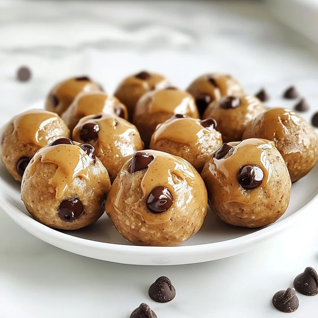 To make these tasty chocolate chip cookie dough protein balls, gather the following items: - 1 cup almond flour - 1/2 cup rolled oats - 1/4 cup vanilla protein powder - 1/4 cup almond butter (or any nut butter) - 1/4 cup honey or maple syrup - 1 teaspoon vanilla extract - 1/4 teaspoon salt - 1/2 cup mini chocolate chips - 2 tablespoons almond milk (or any milk) You can swap almond butter for peanut butter or sunflower seed butter. For sweeteners, use agave syrup instead of honey or maple syrup. These swaps keep the flavor strong while catering to your taste. These protein balls offer a good balance of nutrients. Each ball provides protein, healthy fats, and fiber. The almond flour and oats help with energy, while chocolate chips add a bit of fun. Each serving has about 100 calories. This makes them a great snack for kids and adults alike. They are perfect post-workout or as a midday treat. {{ingredient_image_1}} To make Chocolate Chip Cookie Dough Protein Balls, follow these steps closely: 1. Start with a large mixing bowl. Add 1 cup of almond flour, 1/2 cup of rolled oats, and 1/4 cup of vanilla protein powder. Mix these dry ingredients well. You want to avoid clumps for a smooth texture. 2. Now, add 1/4 cup of almond butter, 1/4 cup of honey or maple syrup, and 1 teaspoon of vanilla extract. Stir until everything blends well. This will create a tasty and creamy base. 3. Next, sprinkle in 1/4 teaspoon of salt. Fold in 1/2 cup of mini chocolate chips and 2 tablespoons of almond milk. If the mix feels dry, add more almond milk, a little at a time, until it forms a nice dough. 4. Using your hands, scoop out about 1 tablespoon of dough. Roll it into a ball shape. Place each ball onto a parchment-lined baking sheet. 5. Keep rolling the dough until you use it all. Make sure the balls are about the same size for even cooking. 6. Once you have rolled all the balls, put the baking sheet in the fridge. Let them chill for at least 30 minutes. This step is key to getting the right texture. Mixing well is very important. Make sure to break any clumps of dry ingredients. This helps the protein balls stay smooth. When you roll the dough, wet your hands slightly. This will stop the dough from sticking to your fingers. If you want, you can make them bigger or smaller. Just keep the size consistent for even taste and texture. Refrigeration is a must for these protein balls. Chilling them helps firm up the dough. This gives the balls a nice bite and makes them easier to eat. If you skip this step, they might be too soft. Aim for a firm yet chewy texture. After 30 minutes in the fridge, they will be perfect for serving or snacking later. To make these protein balls vegan, replace the honey with maple syrup. You can also use a plant-based protein powder. For the nut butter, opt for almond or cashew butter. These swaps keep the flavor tasty and the texture great. You may want to tweak the sweetness. If you like it sweeter, add more maple syrup. Start with a small amount, and mix well. Taste the dough before rolling into balls. This way, you can find your perfect level of sweetness. Store your protein balls in an airtight container. They stay fresh in the fridge for up to a week. If you want them to last longer, freeze them. Just label the container with the date. When you want one, take it out and let it thaw. Enjoy your tasty treat anytime! Pro Tips Texture Matters: For chewier protein balls, slightly underbake them in the fridge; for firmer ones, leave them longer. Flavor Variations: Experiment with different nut butters or add-ins like dried fruits or seeds to customize your protein balls. Storage Tips: Store in an airtight container to keep them fresh longer; you can also freeze them for up to 3 months. Sweetness Balance: Adjust the amount of honey or maple syrup to your taste preference; you can reduce it if you prefer less sweetness. {{image_2}} You can change the flavor of your protein balls easily. Try adding spices like cinnamon or nutmeg. A dash of these spices can bring warmth to your treat. You can also use almond or coconut extract instead of vanilla. This simple swap adds a fun twist to the flavor. Want to make your protein balls even more interesting? Add-ins are a great way to do it. Chopped dried fruits like cranberries or raisins add sweetness and chewiness. You can also mix in seeds like chia or flaxseeds for extra crunch and nutrition. These add-ins make each bite unique and fun. If you follow a special diet, you can still enjoy these protein balls. For a vegan option, use maple syrup instead of honey, and choose a plant-based protein powder. If you need gluten-free, make sure your oats are certified gluten-free. These swaps keep the balls tasty while fitting your needs. To keep your chocolate chip cookie dough protein balls fresh, store them in an airtight container. Place a layer of parchment paper between the balls to avoid sticking. They will stay good in the fridge for up to one week. Check for any signs of spoilage before eating. If they look or smell off, it’s best to toss them. If you want to keep your protein balls longer, freezing is a great option. First, let the balls chill in the fridge for 30 minutes. This makes them firm. Then, place them in a single layer on a baking sheet. Freeze them for about an hour. Once frozen, transfer them to a freezer-safe bag or container. They can last up to three months in the freezer. Just thaw them in the fridge before enjoying. These protein balls are tasty on their own, but you can make them even better. Serve them with a glass of almond milk for a quick snack. You can also enjoy them with fresh fruit like bananas or strawberries. For a fun twist, try drizzling a little almond butter over the top. This adds extra flavor and makes them look pretty on a plate. Yes, you can use different protein powders. Whey, pea, or rice protein works well. Each powder has a unique taste. These differences can change the flavor of your protein balls. Choose a powder that you enjoy. Just make sure the amount stays the same. This keeps the texture right. These protein balls can last up to one week in the fridge. Store them in an airtight container. This helps keep them fresh and tasty. You can also freeze them for longer storage. When frozen, they last about three months. Just thaw before eating. They make a great snack anytime! You can skip the chocolate chips if you like. The balls will still taste good without them. You can add dried fruit or nuts instead. This gives a different flavor and texture. Feel free to experiment with your favorite mix-ins. Enjoy creating your own version! In this article, we explored various ingredients for protein balls and their substitutes. We went over step-by-step preparation and tips for great texture. You learned how to adjust sweetness and even make them vegan. We shared ideas for flavor variations and how to store them properly. Finally, remember that you can customize these protein balls to fit your taste and needs. Enjoy trying different mixes and share them with friends!